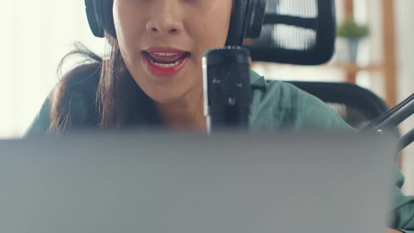 asia girl record a podcast with headphones and microphone look at camera  talk and take a rest.