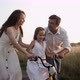 Excited Girl Learning to Ride Bike with Parents Help Outdoors in Countryside - VideoHive Item for Sale
