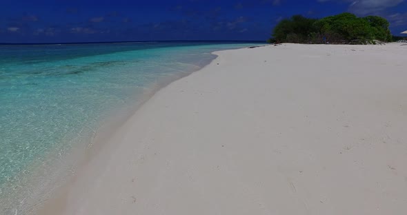Wide angle flying abstract view of a white sand paradise beach and blue water background in hi res 4 alt