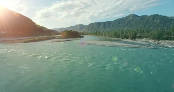 Low Altitude Flight Over Fresh Fast Mountain River with Rocks at Sunny Summer Morning alt