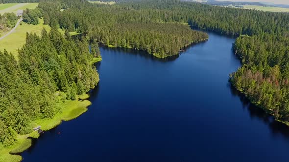 Moorsee in the Swiss Jura filmed from the air alt