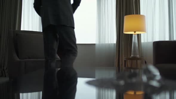 An Elderly Engineer Enters the Hotel Room and Approaches the Window a Grayhaired Architect on a Work alt