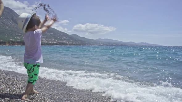 Three Years Old Child Enjoys The Sea At Kalamata Beach Greece SLOW MOTION alt