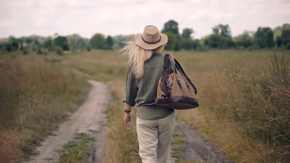 Stylish Lady On Travel Adventure Trip In Africa. Lonely Girl Explore African Prairie In Dry Season. alt