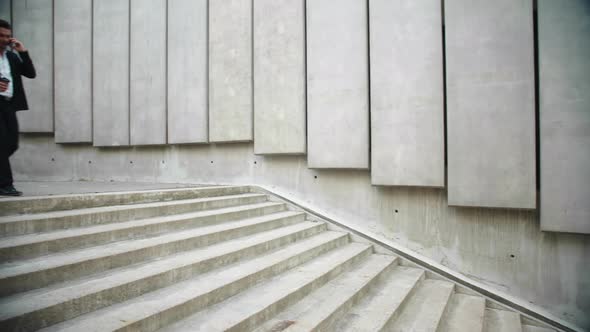Businessman Calling on Smartphone in City. Professional Walking Stairs on Street alt