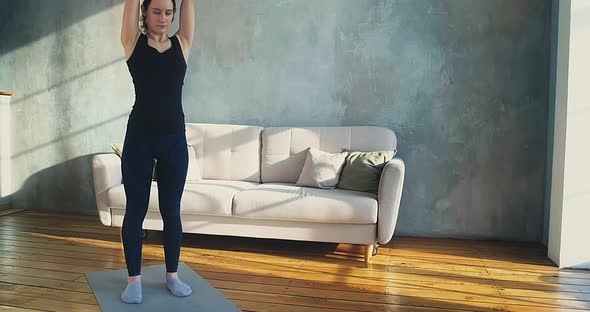Trainer Does Exercises with Weight Plate Posing for Camera alt