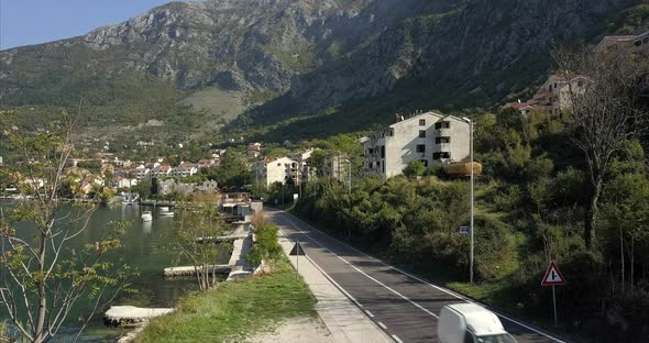 Risan in Montenegro, aerial shot of the main road around the Bay of Kotor, rising up to a wide shot alt