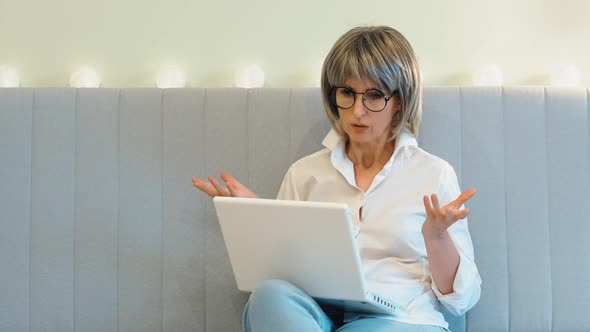 An Angry Businesswoman Indignantly Communicates with Her Subordinate Employees on the Phone and