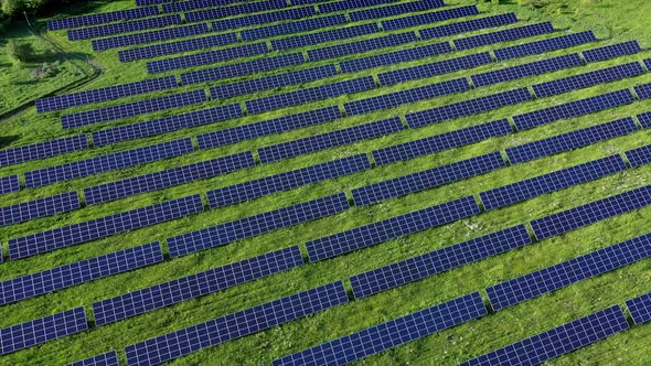 Aerial view on Solar Power Station in Green Field near River at Sunny Day alt