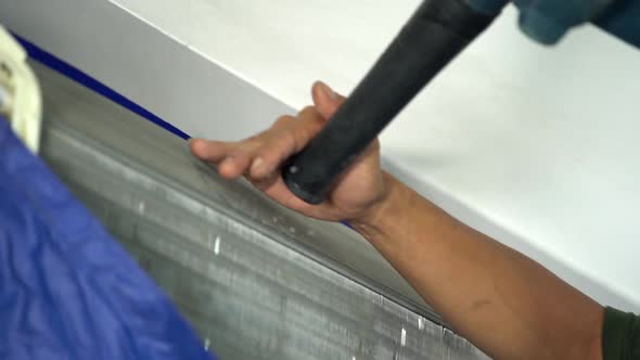 technician service using electric blowers to dry up and dust cleaning the air conditioner alt
