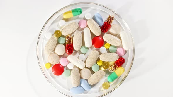 Colorful Medical Pills Rotating Closeup on White Background alt