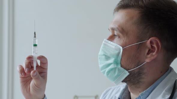 Closeup of Man Doctor Holding Syringe with Vaccine alt