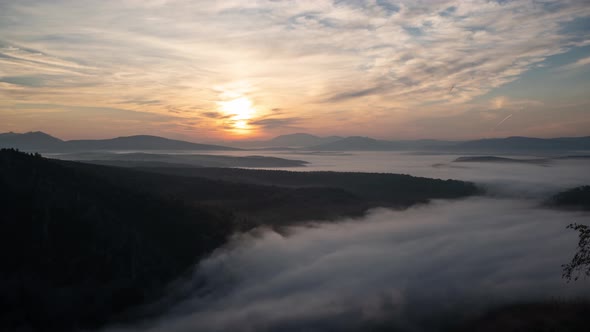 Time Lapse of Sunrise Over Mountains and Drifting Clouds