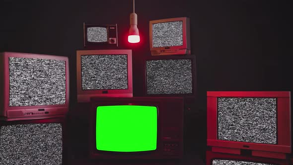Stacked Retro TVs Turning On Green Screens alt