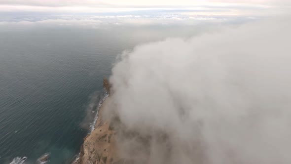 Aerial Shot Flying Over Natural Mountain Fog Over Natural Seascape Scenery with Countryside Village alt