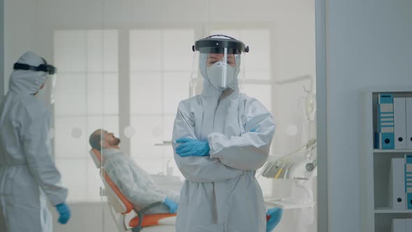 Portrait of Dentist Standing in Hazmat Suit for Virus Protection alt