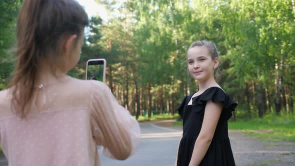 Couple of Girls Makes Video Vlog Grimacing on Camera Closeup alt