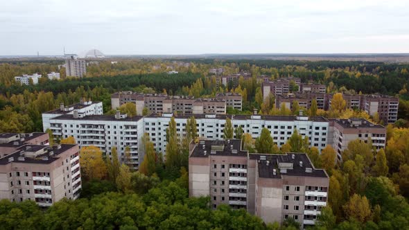 A Drone View of the Abandoned Chernobyl Houses Completely Overgrown with Trees alt