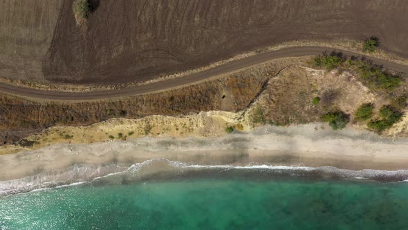 Aerial view to a steep seashore and sand beach