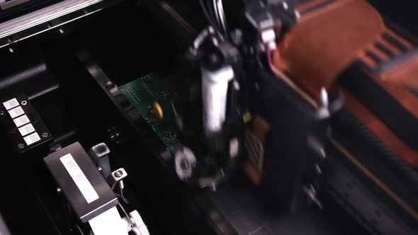 An Automatic Device is Making a Circuit Board