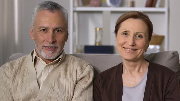 Happy Retired Couple Looking Camera Sitting Sofa, Old Age Vitality, Health alt