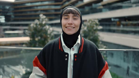 Portrait of Smiling Muslim Woman Looking to the Camera at Modern Shopping Center alt