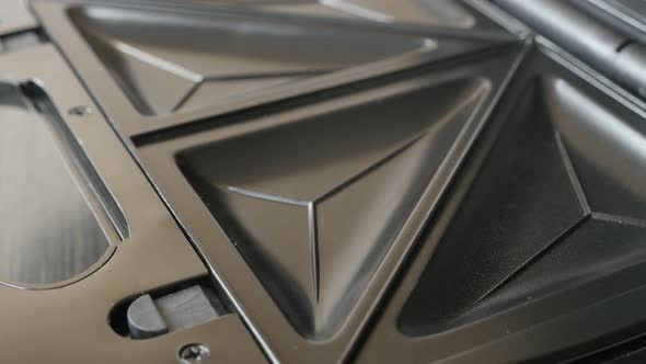 Tilting over non-sticking waffle or  sandwich maker 4K 2160p 30fps UltraHD  footage - Close-up of mo alt