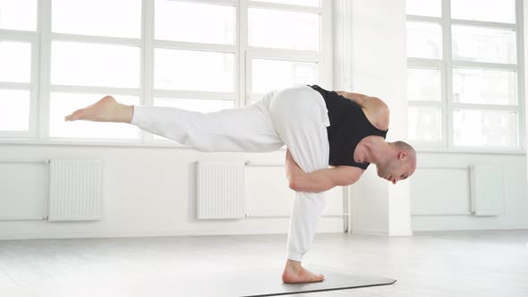 Yogi Male with Bald Head Keep Balance While Performing Posture on One Leg