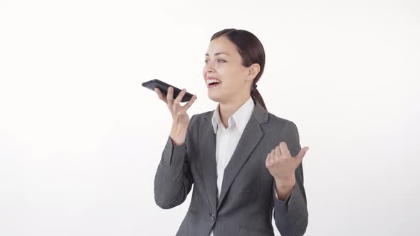 Cheerful Businesswoman Recording Voice Message alt