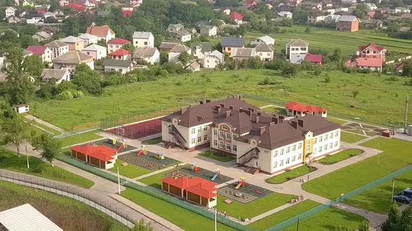 Aerial view of new preschool building in residential area alt