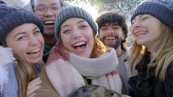 Happy millenial friends taking selfie portrait outside