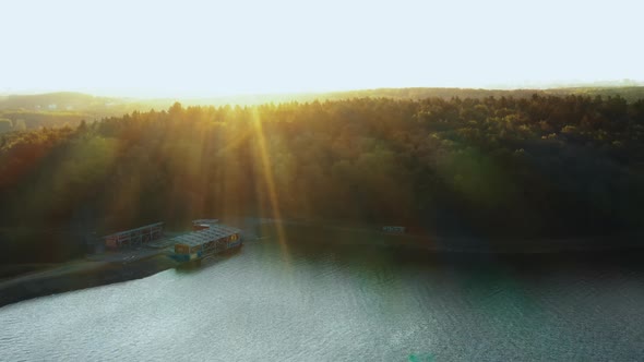 Gorgeous Nature and Urban Skyline, Drone Turning Right Over Calm Autumn Lake and Green Forest alt
