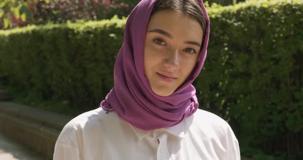 Beautiful Young Woman Looking at Camera, Wearing Traditional Headscarf. Attractive Female in Hijab alt