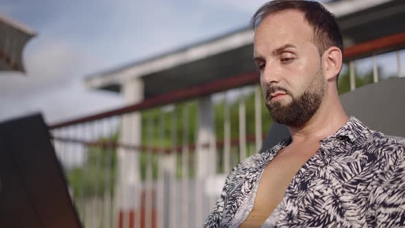 Middleaged Adult Man Having Eyes Tired While Working on Laptop on Vacation  Closeup Slow Motion alt