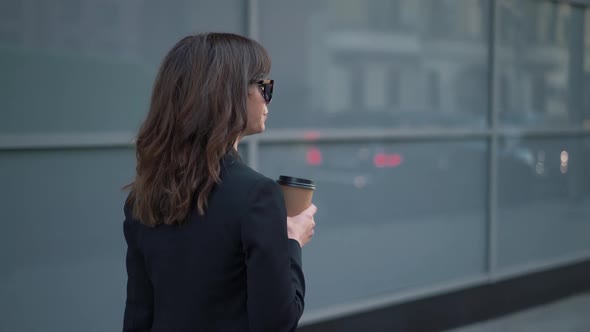 Slow Motion Profile of Business Woman in Sunglasses with a Cup of Coffee