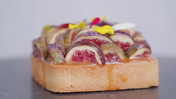 Biscuit with Fig Slices Leaves and Caramel Sauce on Top alt