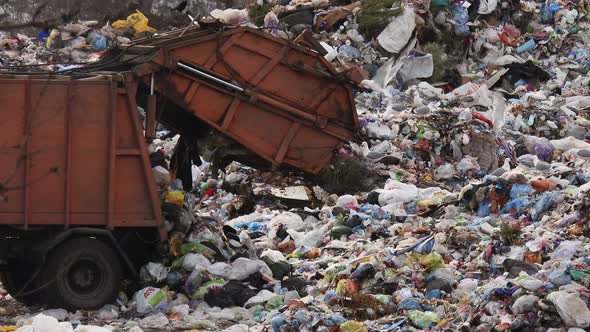 Garbage truck dumps unsorted garbage.