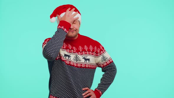 Upset Man in Christmas Red Sweater Making Face Palm Gesture Feeling Bored Disappointed Bad Result alt