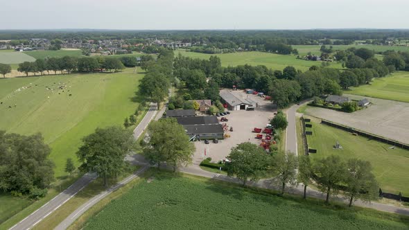 Aerial overview of agricultural company with heavy machinery on lot alt