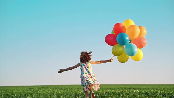Happy Child Playing with Bright Multicolor Balloons by Sunny_studio