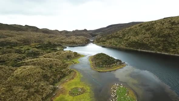 Beautiful aerial drone shot over a mountain range and river in South America alt