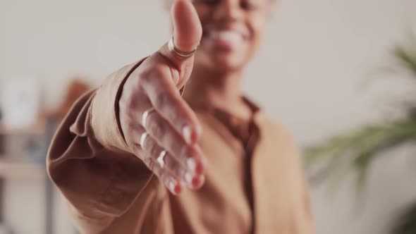 Close Up African Woman Manager Stretching Out Hand Making Hello Gesture alt