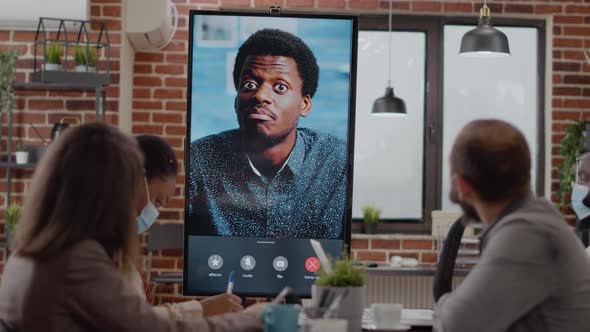Diverse Workmates Talking to Man on Online Video Call Conference alt
