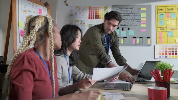 Businessman creative designers present work to the team.Designers a meeting in a modern office.