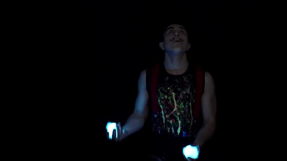 Juggler Showing Tricks with Light Balls in the Whole Dark