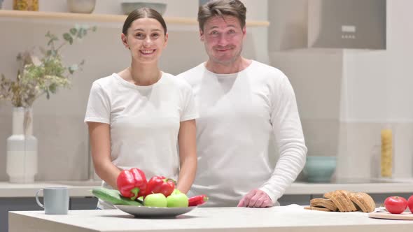 Mixed Race Couple Showing Yes Sign in Kitchen Head Shake alt