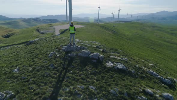 Technician Engineer in Wind Turbine Power Generator Station Launches a Drone for Visual Control of