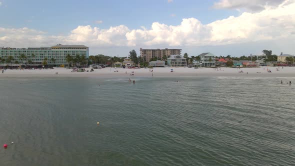 Aerial view of people walking at the beach and waterfront houses in Fort Myers beach, Florida alt