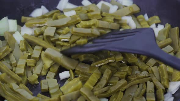 Exotic cactus food being fried with onions. A traditional native Mexican cuisine and street food als alt