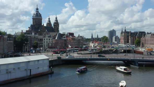 Towards Basilica of Saint Nicholas, Amsterdam Over River with Boat, Aerial Drone alt